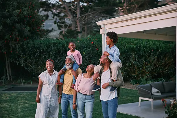 Multigenerational family of six standing together outdoors, representing family protection and legacy planning
